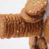 A-close-up-of-a-stack-of-honey-oat-cookies-on-a-white-background-emphasizing-their-warm-color-and-rustic-texture