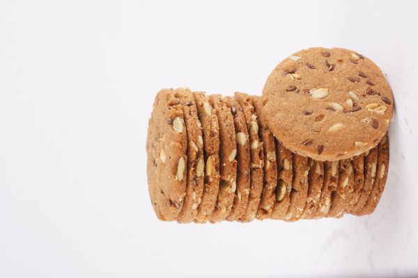 A-neatly-arranged-stack-of-multigrain-cookies-set-against-a-white-background-highlighting-their-wholesome-appearance