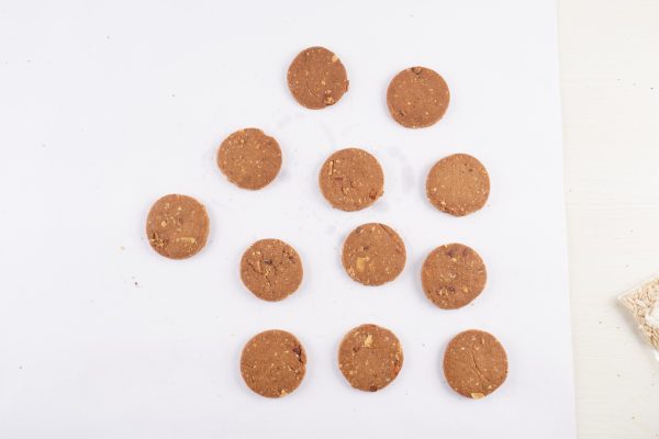 A-pile-of-crispy-almond-cookies-arranged-neatly-on-a-white-surface