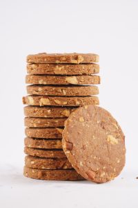 A-stack-of-crispy-almond-cookies-arranged-neatly-on-a-white-background