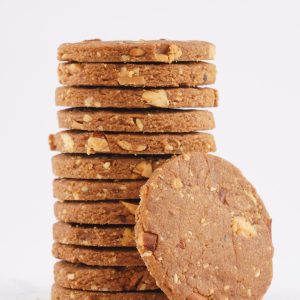 A-stack-of-crispy-almond-cookies-arranged-neatly-on-a-white-background
