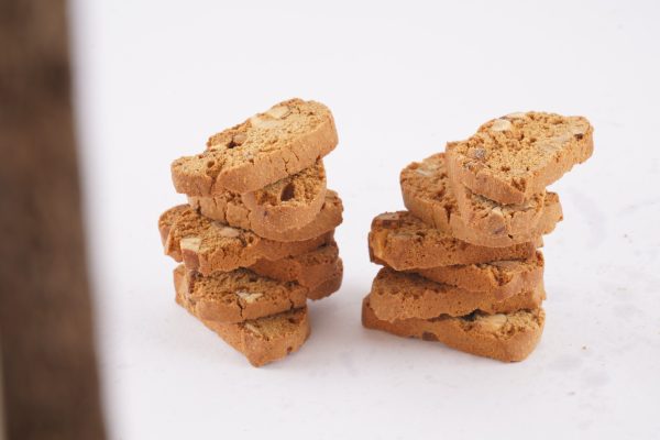 A-stack-of-golden-brown-almond-biscotti-on-a-clean-white-background-emphasizing-their-crunchy-texture-and-appealing-shape