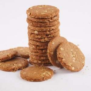 A-stack-of-honey-oat-cookies-on-a-white-background-showcasing-their-golden-brown-color-and-textured-surface