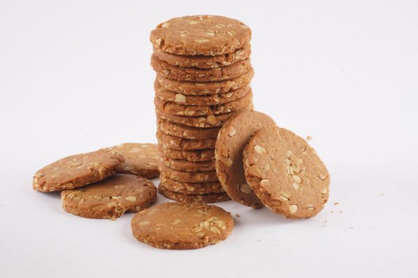 A-stack-of-honey-oat-cookies-on-a-white-background-showcasing-their-golden-brown-color-and-textured-surface