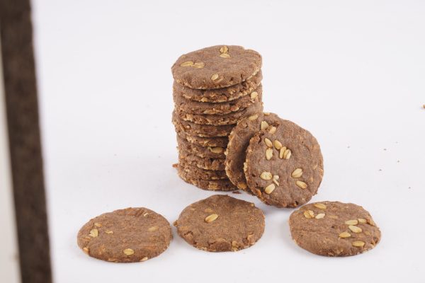 A-stack-of-ragi-oats-cookies-on-a-white-surface-showcasing-their-texture-and-color