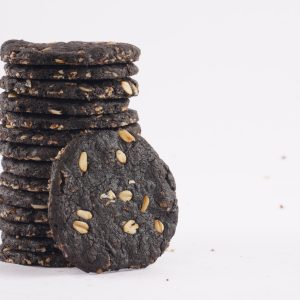 A-tower-of-dark-chocolate-oat-cookies-adorned-with-seeds-highlighting-a-tasty-and-nutritious-snack-option