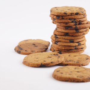 A-white-background-features-a-stack-of-Besan-Chocochip-cookies-emphasizing-their-delicious-chocolate-chips-and-golden-hue