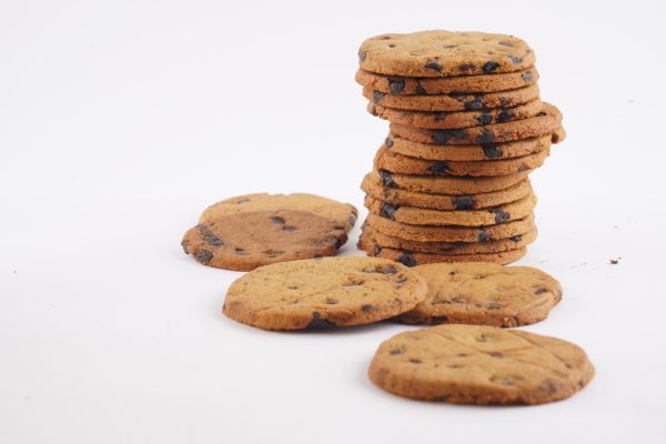 A-white-background-features-a-stack-of-Besan-Chocochip-cookies-emphasizing-their-delicious-chocolate-chips-and-golden-hue