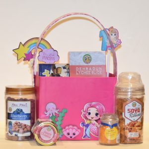 A-pink-basket-filled-with-a-small-box-of-candy-and-themed-items-for-a-kids-mermaid-special-hamper