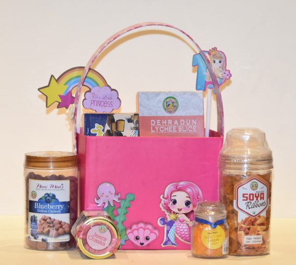 A-pink-basket-filled-with-a-small-box-of-candy-and-themed-items-for-a-kids-mermaid-special-hamper